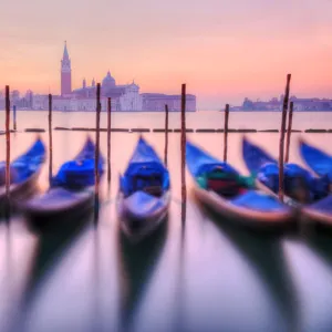 Moored gondolas with San Giorgio Maggiore in the background at dawn, Venice, Veneto