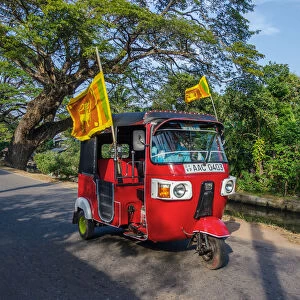 Negombo, Western Province, Sri Lanka, Southern Asia. A Red Tuk Tuk running in the streets