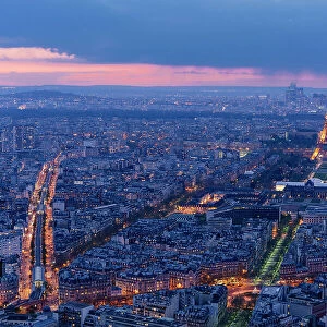 Paris by night from above, streets and Tour Eiffel illuminated after sunset. France