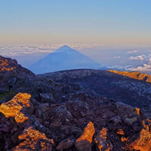 Portugal, Azores, Pico, Sunrise creating a huge shadow of the Mount Pico