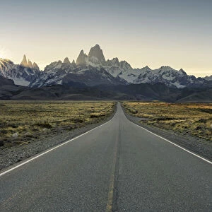 Road leading to El Chalten, with Fitz Roy range in the background at sunset