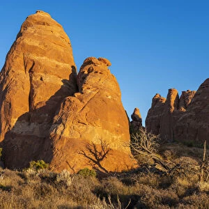 Rock formation illuminated by rising sun, Skyline Arch Trail, Arches National Park, Utah