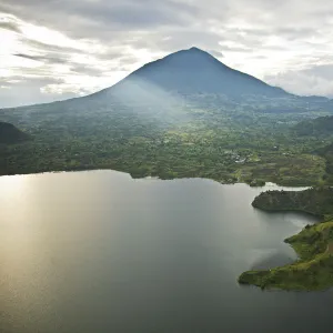 Rwanda. Lake Burero reaches out underneath the volcanoes