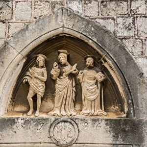 The three saints statues carved above the entrance door of Church of St Luke, Dubrovnik