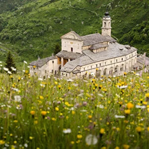 Sanctuary in Grana Valley with a flowery meadow, Castelmagno, Piedmont, Italy