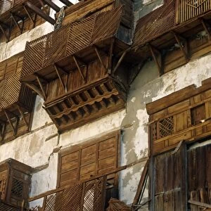 Saudi Arabia, Makkah, Jeddah. Al-Balad, the historic heart of Jeddah, still contains some 19th-century buildings with their distinctive mashrabiyas (Arab oriel windows) - wooden latticework screening windows and supporting small