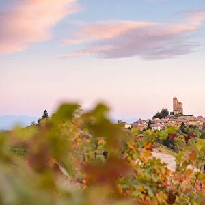 Serralunga d Alba framed by vineyards during autumn sunrise