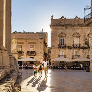 Siracusa, Sicily. People walking on Duomo square near the Cathedral at sunset