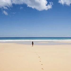 South America, Brazil, Pernambuco, Fernando de Noronha Island, a girl walking along