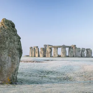 Stonehenge and the Heel Stone at dawn on a chill frosty winter morning, Wiltshire, England. Winter (January) 2022