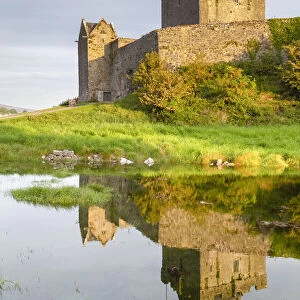 Sunrise at the Dunguaire Castle reflected in its moat. County Galway, Connacht province