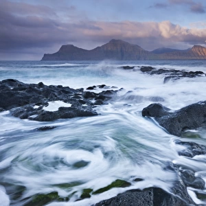 Surging waves break over the rocky shores at Gjogv on the island of Eysturoy, Faroe Islands