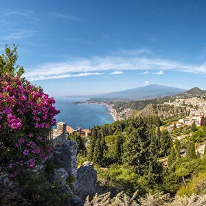 Taormina, Sicily, Italy. The Greek theatre, the cityscape and Mount Etna in the backdrop