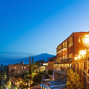 Taormina, Sicily. Luxury hotel by night with Etna volcano in the background