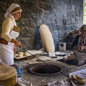 Traditional way of baking bread in the tandoor. Armenia