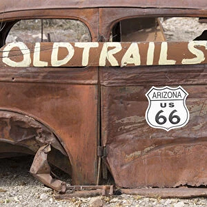 USA, Arizona, Oatman, Route 66, old car rusting away by the side of the road