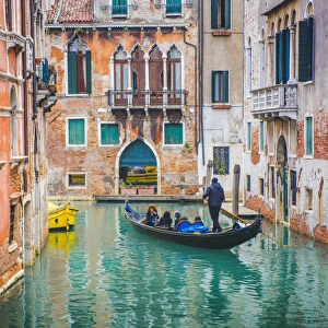 Venice Veneto, Italy. Tourists on gondola and waterfront palaces
