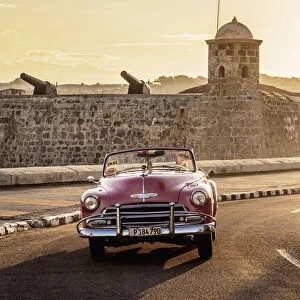 Vintage Car at El Malecon with San Salvador de la Punta Castle in the background, sunrise