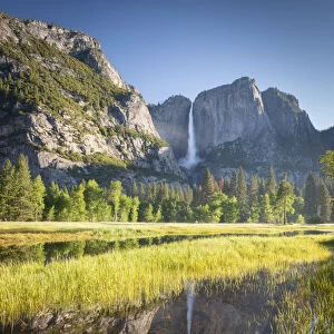 Yosemite Falls reflected in flood waters in Yosemite Valley, California, USA