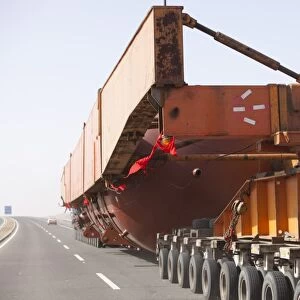 A huge load trundles on a low loader across Inner mongolia in china