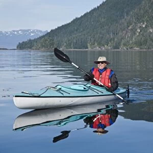 Kayaking in Windham Bay in Southeast Alaska, USA. Pacific Ocean. Kayak property release is DB051905. No model release