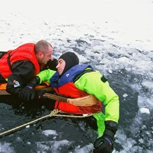 Members of the Langdale Ambleside Mountain Rescue Team rescue a man fallen through ice on Rydal Water in the Lake District