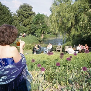 ENGLAND, East Sussex, Glyndebourne Opera attendees enjoying picnics in the gardens