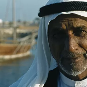 Qatar, Doha, Portrait of a man in the harbour wearing traditional head covering with a