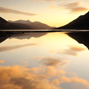 Sunset coloured clouds reflected in Loch Etive