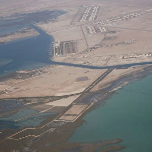 An aerial view of Arabian Gulf with city of Abu Dhabi is pictured through the window of