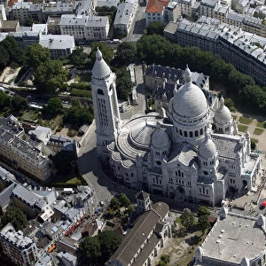 An aerial view shows the Sacre Coeur Basilica and rooftops of residential buildings