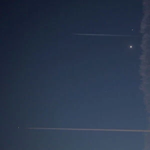 Aircraft fly past with the crescent moon and planets Venus