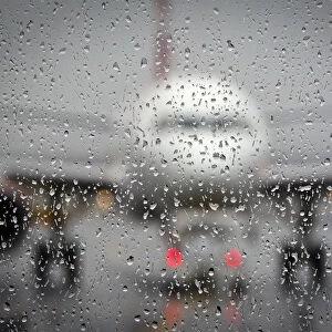 Airplane is pictured though a rain-coated window on the day before Christmas at LaGuardia