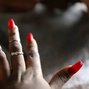 A client presents her nails after they have been painted on Valentines Day at Wuse