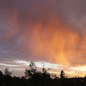 Cloud formations are illuminated by the sun as it sets in Los Angeles