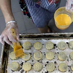 An employee makes mooncakes with anti-extradition bill slogans at Wah Yee Tang Bakery in