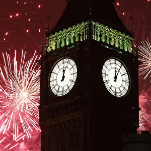 Fireworks explode behind The Big Ben clock tower during New Year celebrations in London