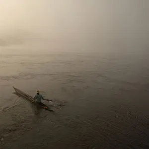 A fisherman paddles his boat on the river Oubangui in Bangui