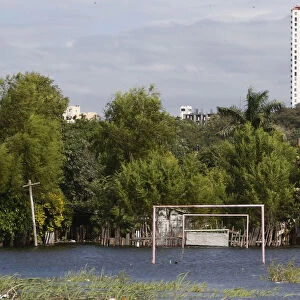Goalposts stand in a soccer field flooded by the waters of the Paraguay River in Asuncion