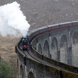 The Jacobite steam train crosses the Glenfinnan Viaduct in Scotland