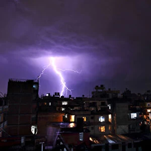 Lightning strikes over buildings during a thunderstorm in Kathmandu