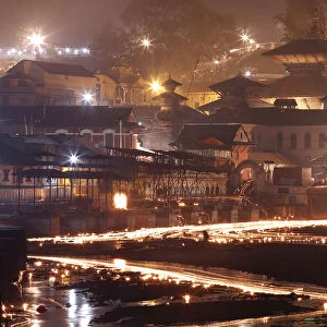 Oil lamps illuminate the Bagmati River in the Pashupatinath Temple