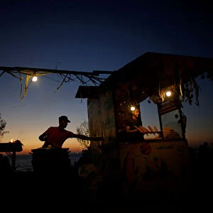 Palestinian vendors sell corns on the beach in Gaza City
