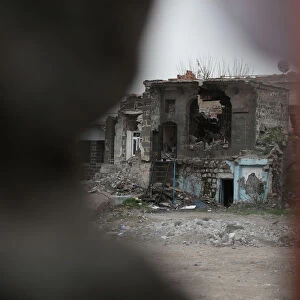 A partial view from behind a banner of Sur, a historical district ravaged by urban