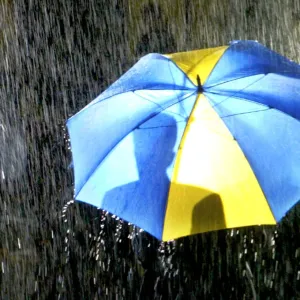 PEOPLE SHELTER UNDER UMBRELLAS AS TORRENTIAL RAIN FALLS IN LONDON