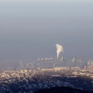 A power station is seen through smog covering Almaty