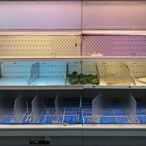 An empty refrigerator is seen at a supermarket in Caracas