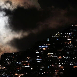 The rising supermoon is seen over the slum of Petare in Caracas