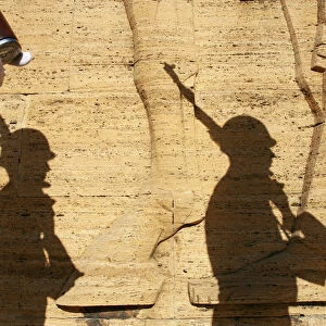 Shadows of the Turkish soldiers are seen on a wall as they wait for the start of a