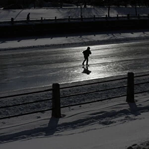 A skater is silhouetted on the Rideau Canal in Ottawa